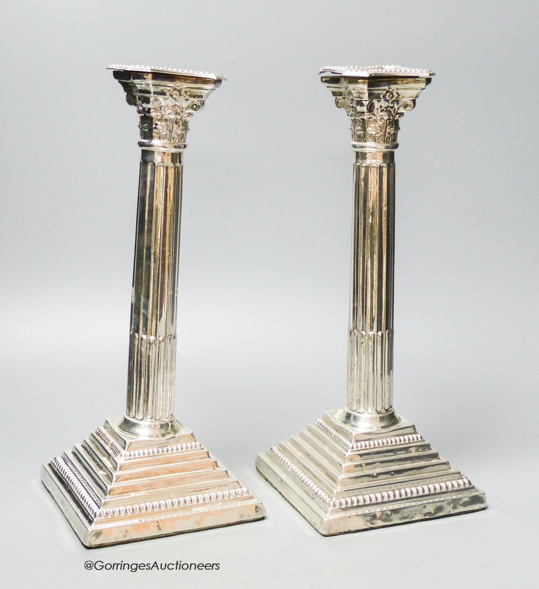 A pair of 1960's silver Corinthian column candlesticks, D J Silver Repairs, London, 1967, 30cm, weighted (a.f.).